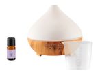 White ceramic essential oil diffuser with wooden base, includes oil bottle and measuring cup.