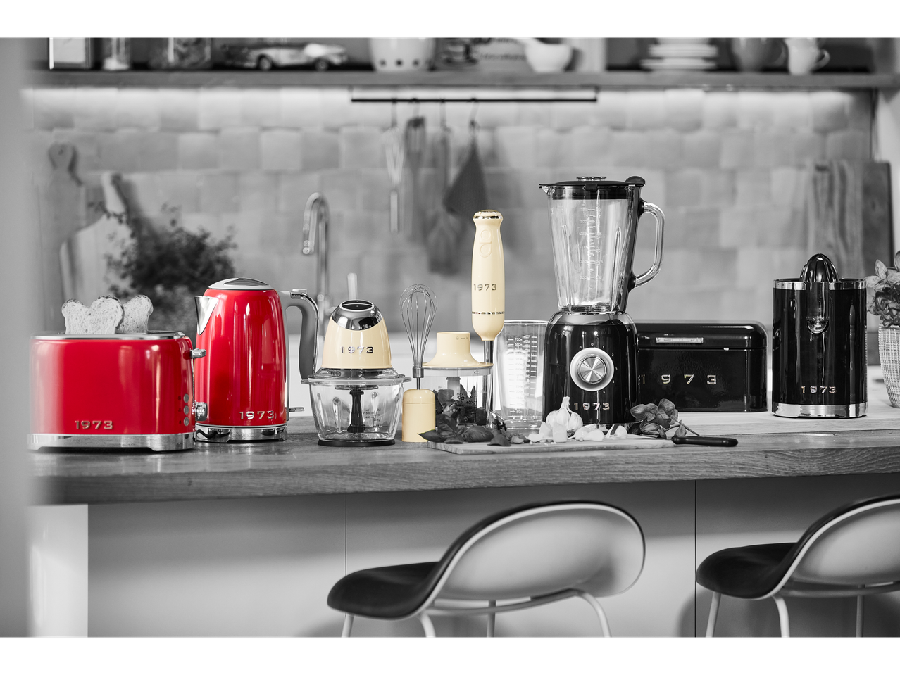Kitchen counter with red toaster and kettle, cream blender, and black blender.
