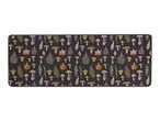 Rectangular mat with a pattern of mushrooms, ferns, and autumn leaves on a dark background.