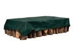 Green tarpaulin covering a stack of firewood logs.