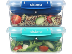 Two Sistema lunch boxes, one blue with quinoa salad, one teal with green salad.