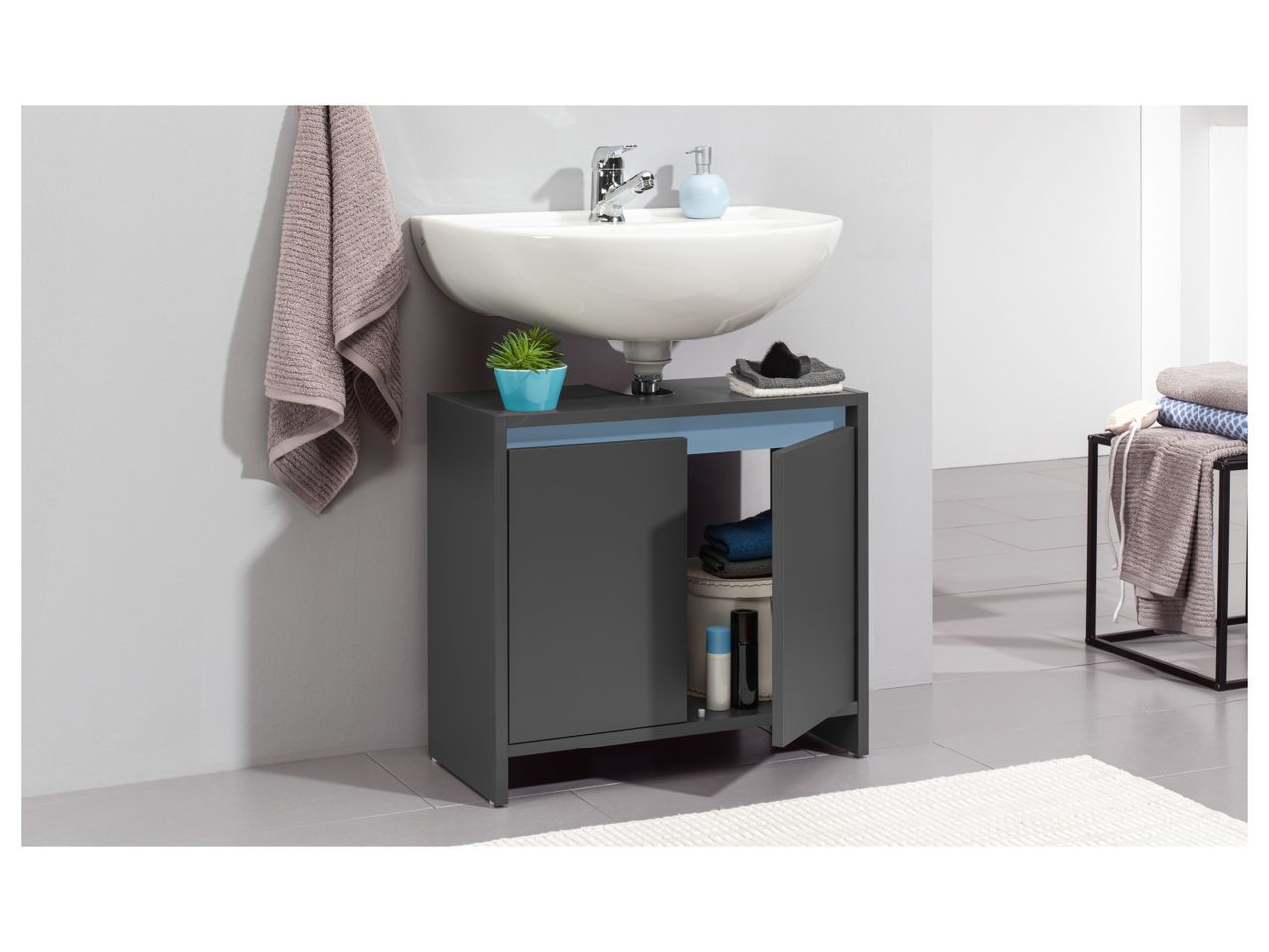 A modern dark gray bathroom Under Sink Storage Unit with a white sink and storage space.