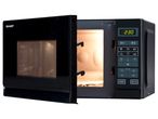 A black Sharp microwave oven with its door open, showcasing the interior.