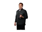 Man in dark shirt holding a cordless drill, looking at the camera.