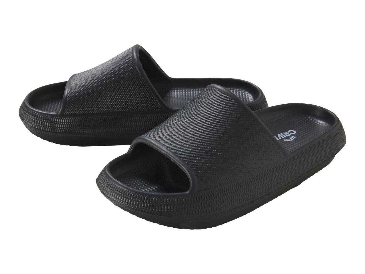 Pair of black, textured slide sandals with thick soles.