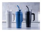 Three Fackelmann insulated tumblers with handles and straws in white, blue, and black.