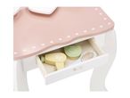 Pink and white wooden vanity table with a drawer open, showing toy hairdryer and brush.