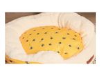 A cozy pet bed with a cream fluffy exterior and a yellow interior cushion with a bee pattern.