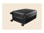 Black hard-shell suitcase with four spinner wheels, lying on its side.
