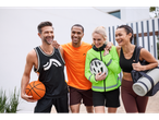 Four friends smile while wearing sportswear and sporting goods.