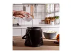 A person pouring water into a VonShef rice cooker on a kitchen counter.