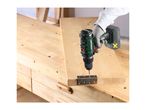 A person using a cordless drill to screw a metal hinge onto a wooden board.