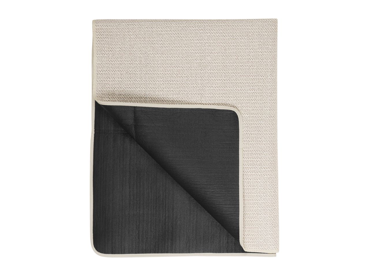 Folded beige and black picnic blanket