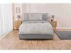 A gray platform bed with a beige and gray geometric duvet cover and pillows sits in a minimalist bedroom.