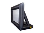 Inflatable outdoor movie screen with a white projection surface and black frame.