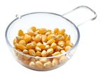 Popcorn kernels in a clear measuring cup.