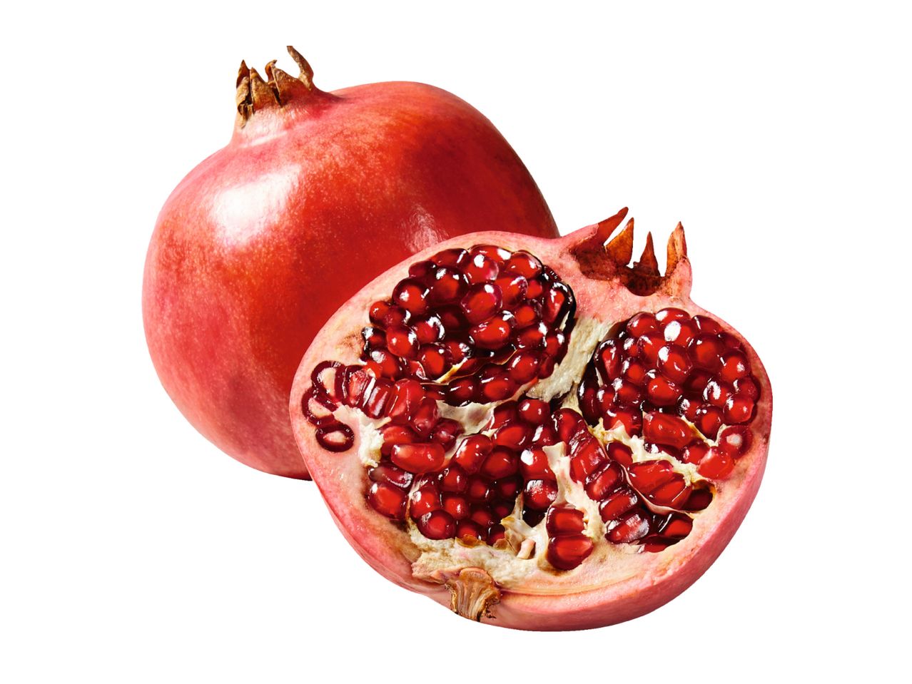 A whole pomegranate and a halved pomegranate showing red seeds