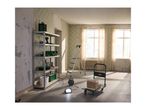 Room being renovated with a metal shelving unit, step ladder, and hand truck with boxes.