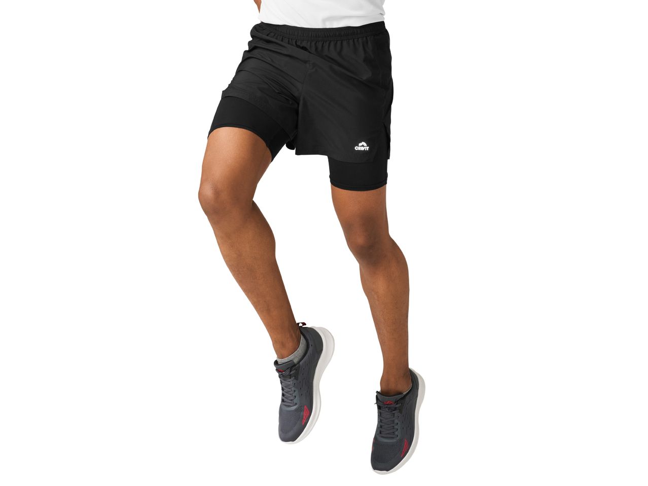 A man wearing Crivit 2-in-1 running shorts and dark gray athletic shoes.