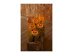 Halloween pumpkin lights in a planter with fake spiderwebs and spiders