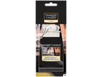 Yankee Candle Black Coconut auto luchtverfrisser met een afbeelding van een strand bij zonsondergang.