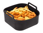 Air fryer basket filled with crinkle-cut fries, onion rings, and breaded chicken pieces.