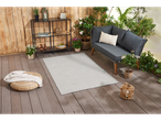 Tapis gris géométrique sur une terrasse avec un canapé et des plantes.