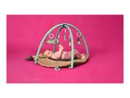 Baby lying on a brown playmat with a green activity arch, reaching for a toy.