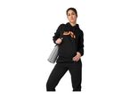 Woman in black hoodie and sweatpants holding a yoga mat.