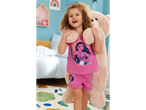 Child in Moana pajamas with a plush toy.