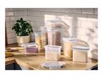 A selection of airtight plastic food storage containers filled with dry goods on a kitchen counter.