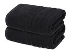 Two folded black towels stacked on top of each other.