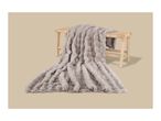 Fluffy grey faux fur blanket draped over a light wooden bench