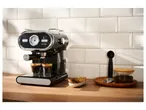 SilverCrest espresso machine making coffee on a kitchen counter with cookies and coffee beans