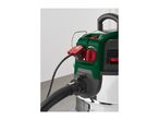 Close-up of a wet and dry vacuum cleaner with a power tool socket and hose attached.
