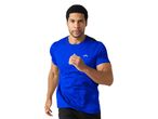 A man in a blue running shirt is jogging.