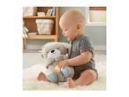 Baby playing with a light-up plush otter toy on a fluffy rug.