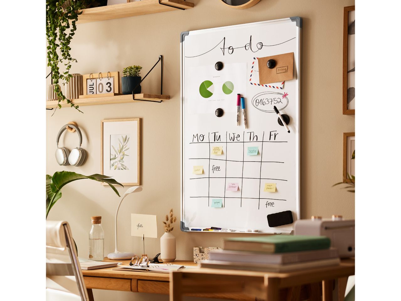 Home office with whiteboard calendar, desk lamp, and plants, featuring a 'To Do' list.
