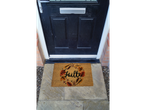 Autumn coir doormat in front of a black front door