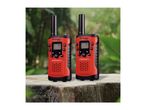 Two red and black walkie-talkies with screens and buttons, on a wooden surface outdoors.