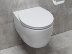 A wall-hung toilet with a closed seat.