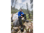 Man in CRIVIT thermal softshell jacket and hiking boots by a waterfall.