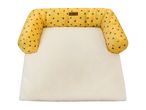 Yellow pet bed with a bee pattern and a cream fleece base, featuring a Cath Kidston label.