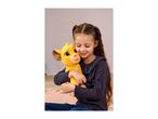 Young girl hugging a yellow plush toy, smiling with eyes closed.