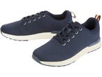 A pair of navy blue knitted sneakers with cream-colored soles.