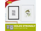 3M Command hooks securely hold picture frames on the wall.
