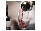 Red wine being poured from a vacuum wine preserver into a glass.