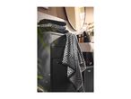 Black and white patterned towels on a dark grey bathroom cabinet with a mirror in the background.