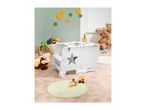 A white children's activity table with a star cutout in a playroom.