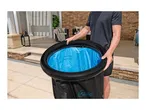 Man holding an inflatable ice bath with blue interior and 'MAX' and 'MIN' water level indicators.
